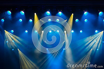 Lighting equipment on the stage of the theatre during the performance. The light rays from the spotlight through the smoke Stock Photo