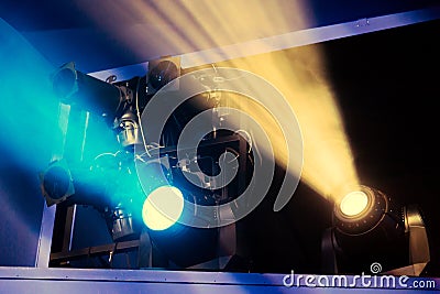 Lighting equipment on the stage of the theatre during the performance. The light rays from the spotlight through the smoke Stock Photo