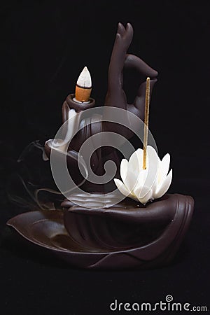 Burning incense on black background in zen figure Stock Photo