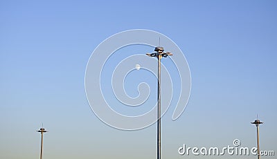 Lighting poles of the airfield against the background of a bright moon Stock Photo