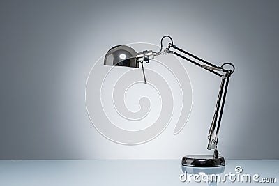 Lighting up office desk lamp for reading studying Stock Photo