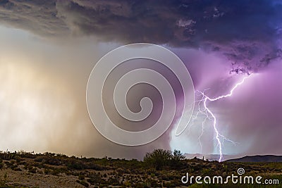 Lightning bolt strikes next to a microburst in a thunderstorm. Stock Photo