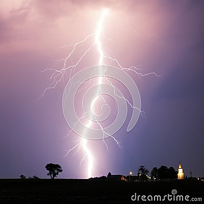 Lightning bolt at strom over village Stock Photo