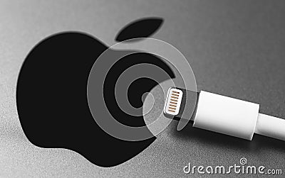 Lightning cabel and Apple logo on Apple device. Apple Lightning Connector used to connect mobile devices iPhones, iPads and iPods Editorial Stock Photo