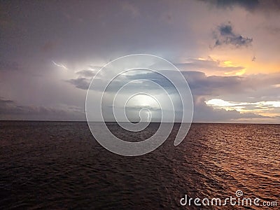Lightning over the sea on a summer evening Stock Photo