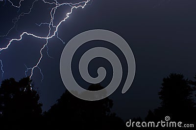 Lightning over the trees Stock Photo