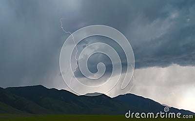 Lightning shoots out from thunder storm clouds over Idaho plains Stock Photo