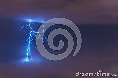 Lightning strike flash, electric discharge between clouds at night Stock Photo