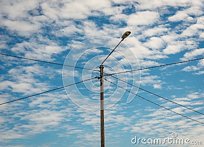 Lightpost with electrical wires connecting in a cross Stock Photo