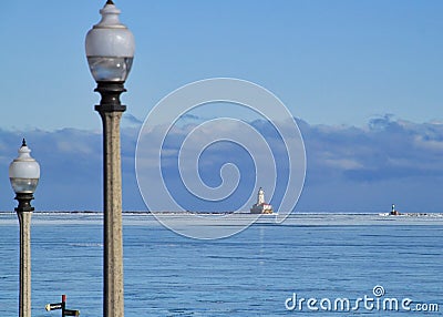 Lightpost in foreground with cloudscape over horizon of Lake Michigan on a freezing January morning with frozen lake Stock Photo