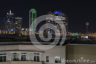 Lights of the Dalllas skyline at night behind apartment building Stock Photo