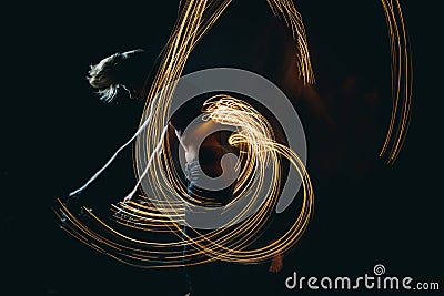 Lights dancer in the dark. Top naked man dynamic movement. Long exposure creative portrait Stock Photo