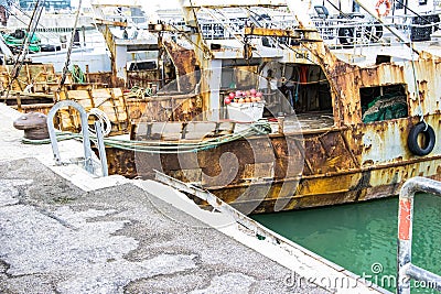 Liguria Italy - Old trawler fishing boats with fishing equipment docked in port Editorial Stock Photo