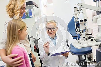 Likable eye specialist gives eye glasses to child Stock Photo