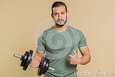 Athlete man looking approvingly at camera showing thumbs up, like sign positive something good Stock Photo