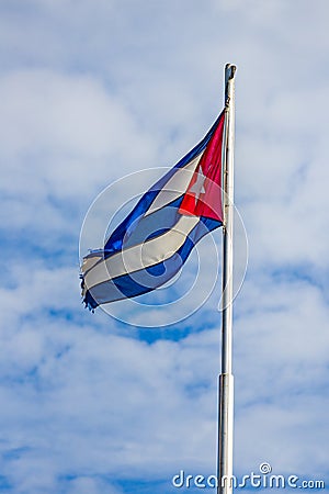 Like the country, the Cuban flag tattered around the edges Stock Photo