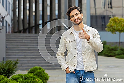 Happy Indian man show thumbs up like sign positive something good positive feedback in city street Stock Photo