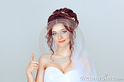 Like. Woman girl in wedding dress bride spouse showing thumb up success sign hand gesture. Portrait of beautiful bride isolated Stock Photo