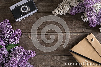 Lilac blossom on rustic wooden background with notebook for greeting message. Top view Stock Photo