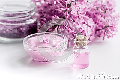 Lilac cosmetics with flowers and spa set on white table background Stock Photo