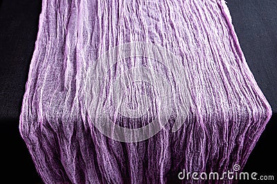Lilac gauze scarf on a black background. Close-up Stock Photo