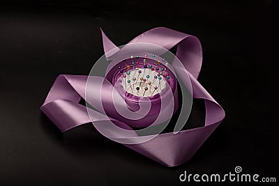 lilac silk ribbon, needles, sewing things on background Stock Photo