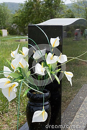 Lilies in Gravestone Vase Stock Photo