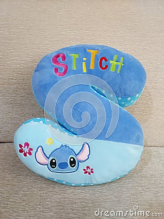 Lilo & Stitch, Disney cartoon character Stitch pillow, blue S-shaped cushion. Editorial Stock Photo