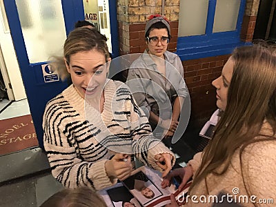 Lily James signing autuographs outside The Noel Coward Theatre following her performance in All About Eve. Editorial Stock Photo