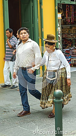 Lima, Peru - 03.01.2019. Couple of man and old woman, people in modern and traditional dress on the street of Lima, capital Peru Editorial Stock Photo