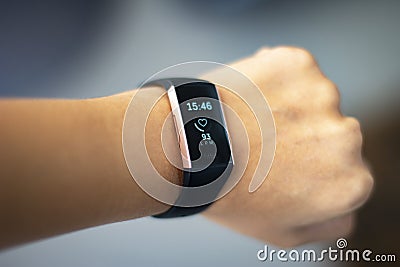 Woman monitoring her heart beat with a fitbit Editorial Stock Photo