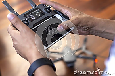 Man controlling DJI Mavic 2 Pro drone in the ground Editorial Stock Photo