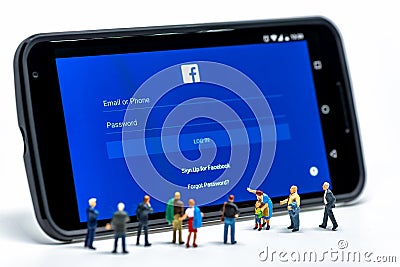 LIMASSOL, CYPRUS - DECEMBER 07, 2015: Group of people watching at Facebook application sign in page on smartphone. Social networki Editorial Stock Photo