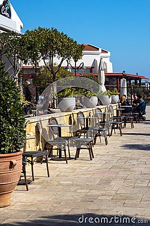 Limassol, Cyprus, February 2020. A cozy fish restaurant on a bright sunny day in the port of Limassol Marina, Cyprus. Editorial Stock Photo