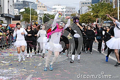 Happy people in teams dressed with colourful costumes dancing and parading at famous limassol carnival parade in cyprus Editorial Stock Photo