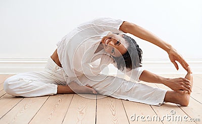 Limber and invigorated. A pretty young woman doing stretches before a workout. Stock Photo