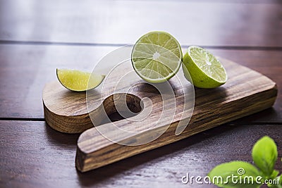 Lime and basil on wooden board Stock Photo