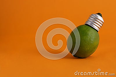 Lime with a bulb base on orange background Stock Photo