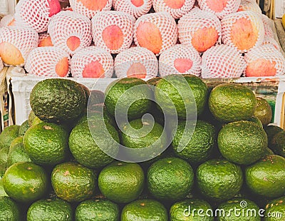 Lime citris fruits in supermarket. Limes green background. Stock Photo