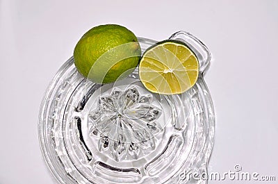 Lime citrus, whole and cut on glass juicer Stock Photo