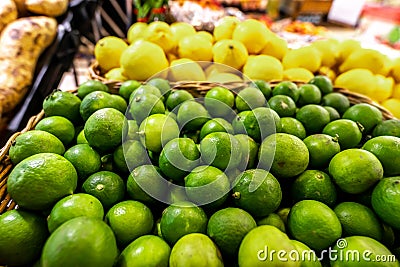 Lime and lemons background. Fresh organic lemons and lime on a local farmer food market on Bali island. Stock Photo