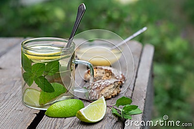 Lime tea with mint and honey and gingerbread on a wooden table Stock Photo