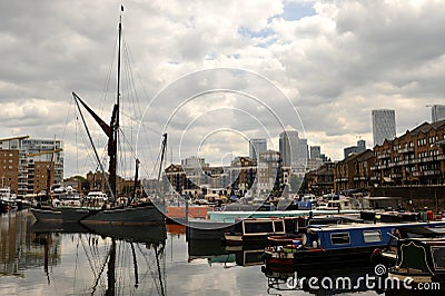 The Limehouse Basin in Limehouse, in the London Borough of Tower Hamlets with houseboats and skyscrapers in the distance Editorial Stock Photo