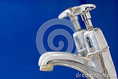 Limescale. Chrome faucet tap with hard water calcification deposit close-up Stock Photo