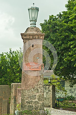 Limestone, architectural column, and street sign and brass light fixture Editorial Stock Photo