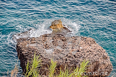 Limestone cliffs by sea. Waves beat on the Stock Photo