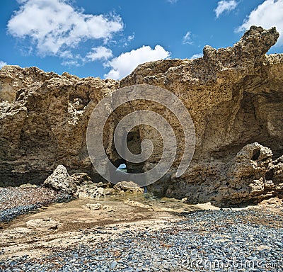 Limestone hole on cypriot coast Stock Photo