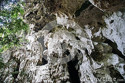 Limestone Rock Exterior Formation with Dark Entrance Hole Fancifully Carved by Nature Stock Photo