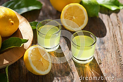 Limoncello, Italian liqueur with lemons. Traditional Mediterranean sweet shot alcoholic drink close up Stock Photo