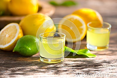 Limoncello, Italian liqueur with lemons. Traditional Mediterranean sweet shot alcoholic drink close up Stock Photo